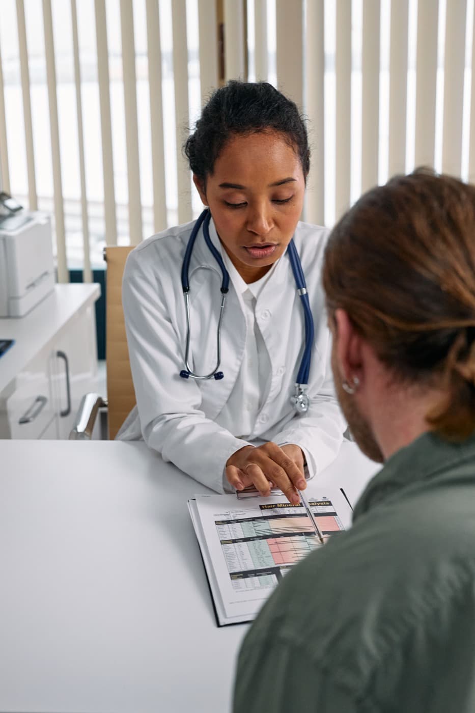 A clinician reviewing billing paperwork with a patient