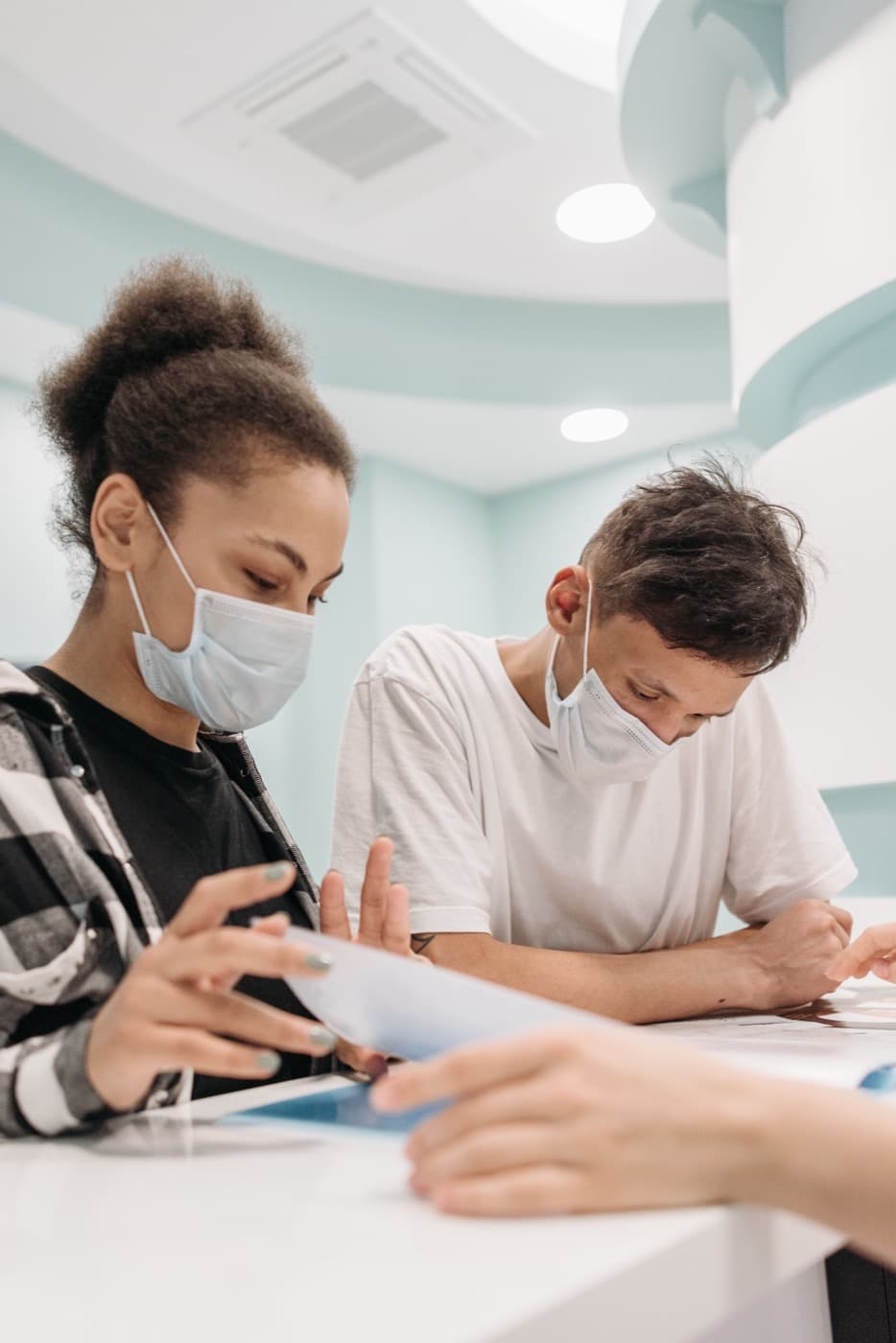 Patients reviewing medical paperwork together at a clinic desk